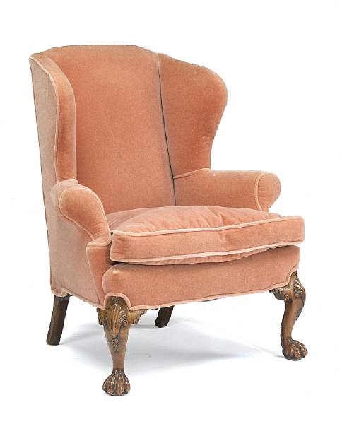 Appraisal: The arched upholstered back and wings over out scrolled arms