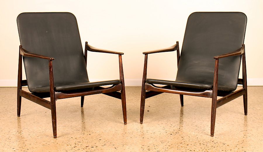 Appraisal: MID CENTURY MODERN LEATHER AND WOOD ARM CHAIRS An unusual