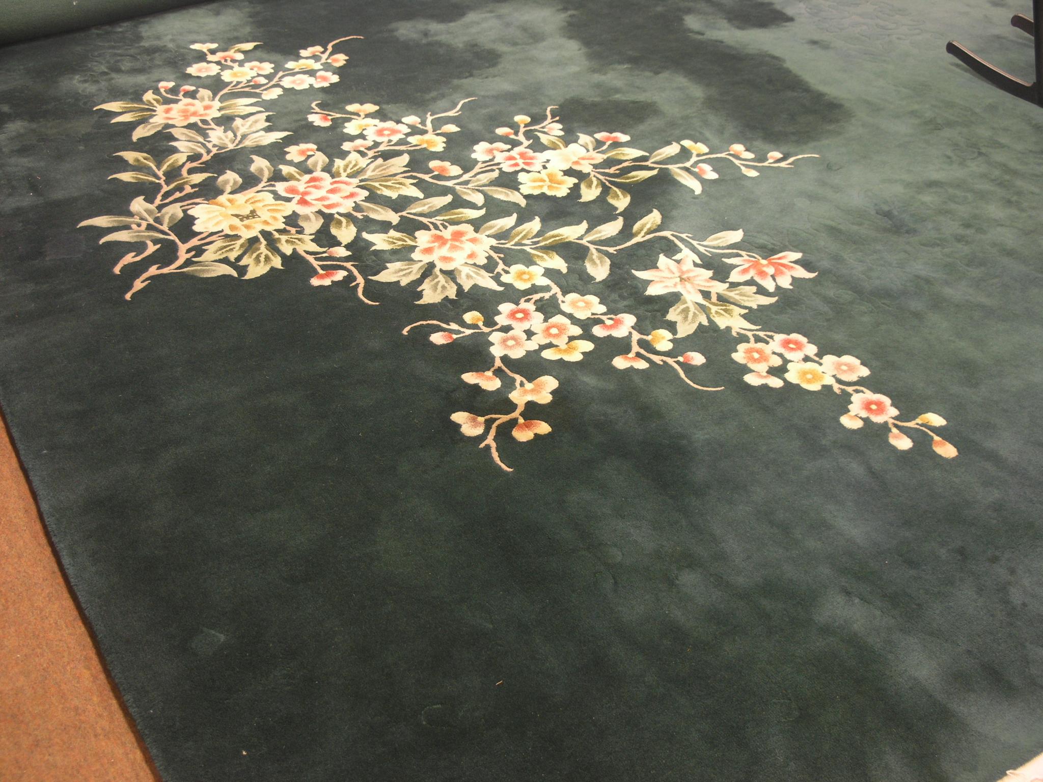 Appraisal: A large Chinese wool rug bright floral designs against a