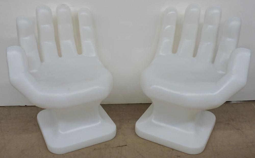 Appraisal: PAIR OF MOLDED PLASTIC HAND-SHAPE CHAIRS IN THE MANNER OF