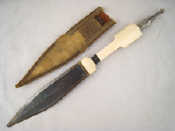 Appraisal: An Eastern dagger with ivory grip white metal finial and