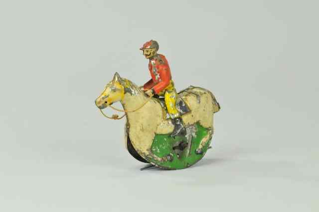 Appraisal: MAN ON HORSE TIN TOY Germany hand painted depicts Jockey