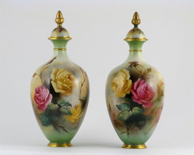 Appraisal: A pair of Royal Worcester vases and covers decorated with