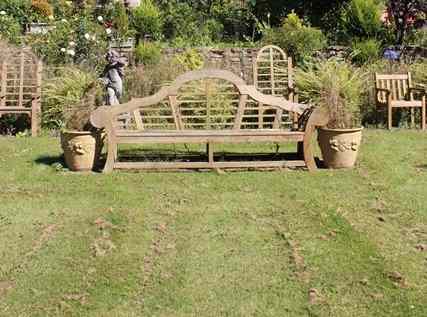 Appraisal: A SET OF FOUR TEAK GARDEN ARMCHAIRS with arching backs