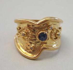 Appraisal: A sapphire and diamond set wide band ring mounted with