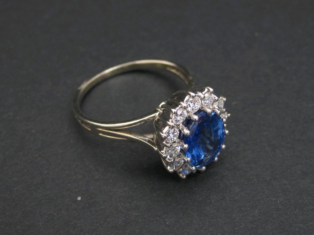 Appraisal: A Sapphire and Diamond Cluster Ring claw-set central oval-cut sapphire