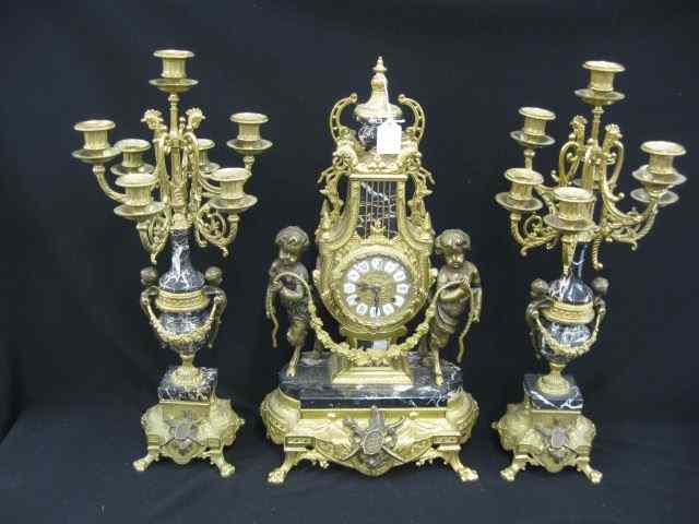 Appraisal: French Style Clock Garniture Set elaborate brasswork with mythological figures