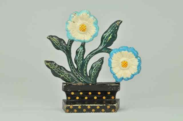 Appraisal: a MODERNISTIC FLOWER POT DOORSTOP Beautiful cast iron doorstop depicts