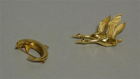 Appraisal: TWO LADY'S GOLD BROOCHES The first of a dolphin and