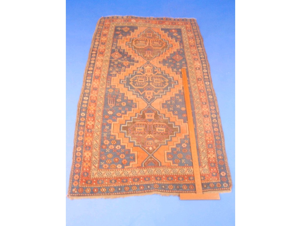 Appraisal: A Bokhara rug with three medallion field on a blue