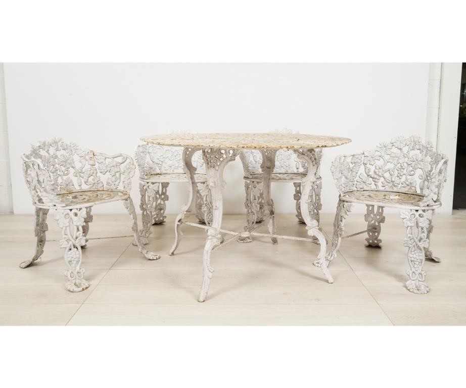 Appraisal: Cast iron grape vine pattern round garden table and four