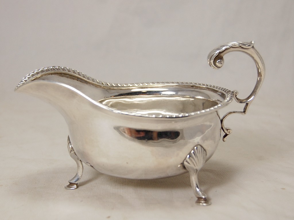 Appraisal: Victorian gadroon-edge silver sauce boat on three feet with flying