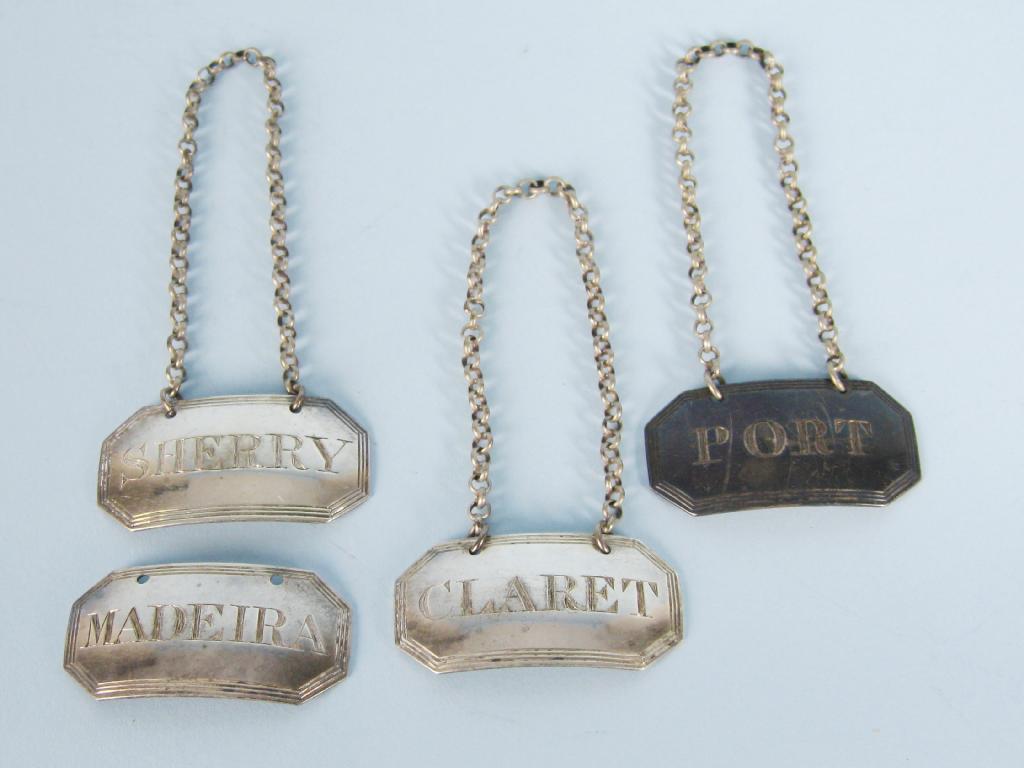 Appraisal: Four George IV reeded octagonal Bottle Tickets Port Sherry Claret