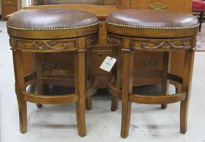 Appraisal: PAIR OF LOW BAR STOOLS with circular revolving leather seats