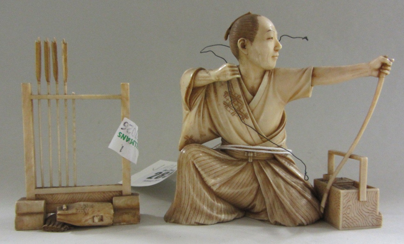 Appraisal: A Japanese ivory okimono of an archer Meiji period carved