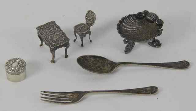 Appraisal: A silver miniature table and chair a silver shell shaped