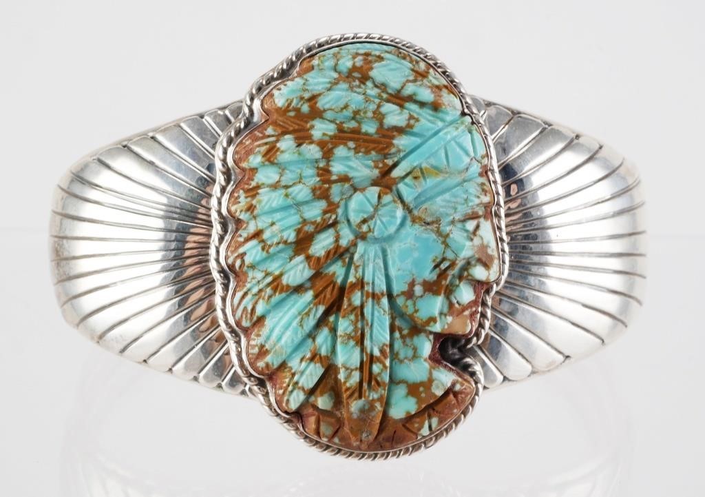 Appraisal: Sterling silver cuff bracelet featuring Native American style carved turquoise