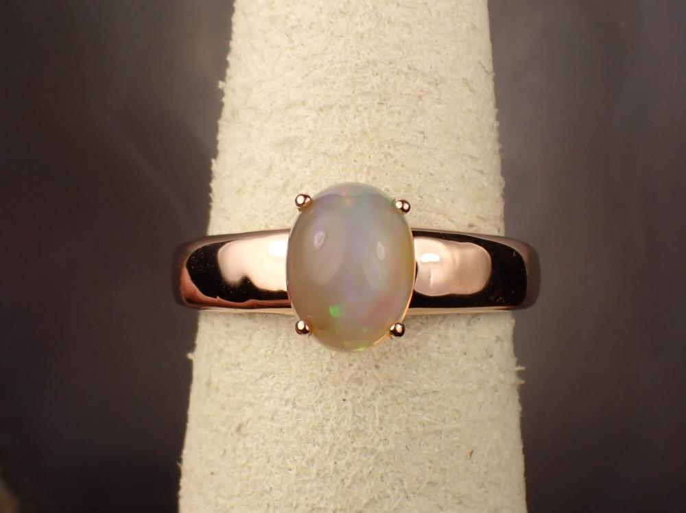 Appraisal: OPAL AND FOURTEEN KARAT ROSE GOLD RING with an oval