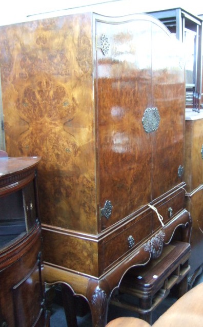 Appraisal: A th century burr walnut cocktail cabinet with a pair