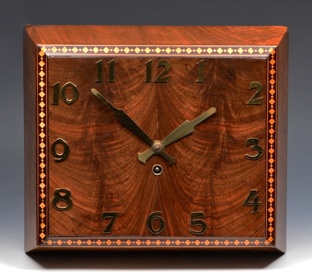 Appraisal: AN ART DECO WALL TIMEPIECE the frame mahogany rectangular dial