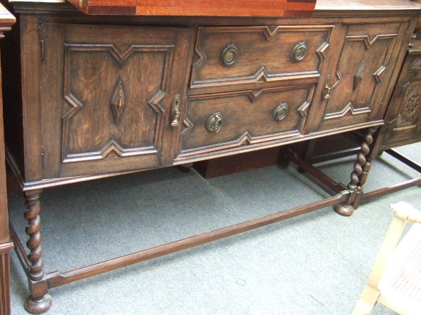 Appraisal: A mid th century oak sideboard with a pair of