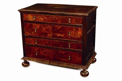 Appraisal: An oak and walnut veneered chest with four long drawers