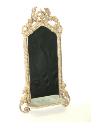 Appraisal: A giltwood wall mirror the ribbon and foliate carved crest