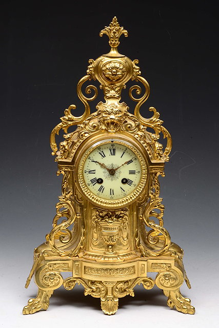 Appraisal: A FRENCH GILT METAL MANTEL CLOCK of ornate scroll form