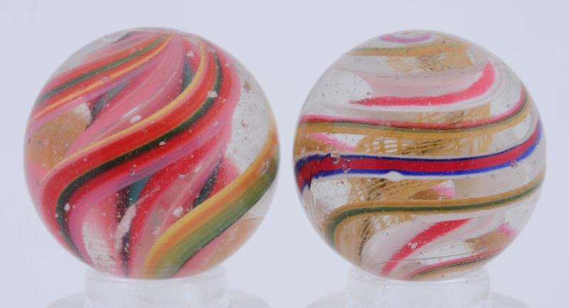 Appraisal: Lot Of Ribbon Swirl Marbles The smaller is a complex