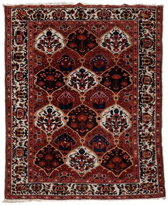 Appraisal: Baktiari rug repeating cartouche shaped designs on orange red field