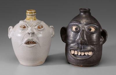 Appraisal: Two Face Jugs Southern modern one salt glazed and marked