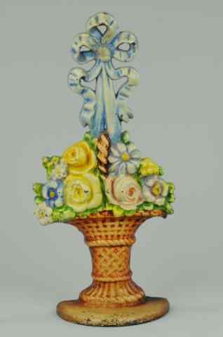 Appraisal: MIXED FLOWERS IN WICKER BASKET WITH BOW DOORSTOP Large cast