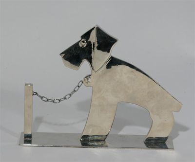 Appraisal: A Hagenauer silvered bronze figure of a terrier modelled chained