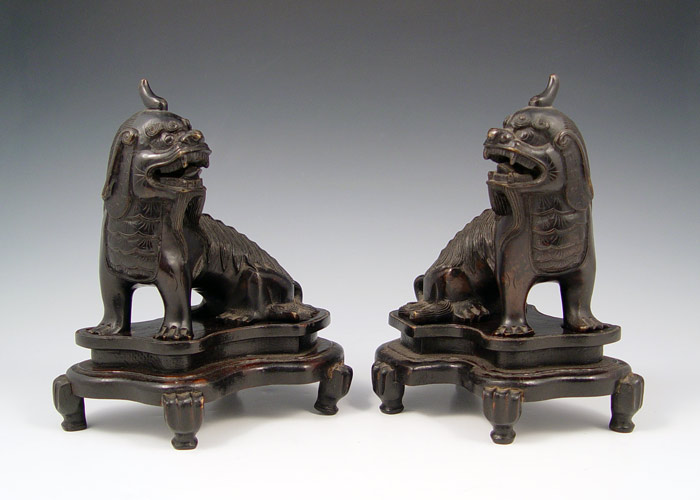 Appraisal: PAIR OF BRONZE ASIAN FOO DOGS Dressed in head armor