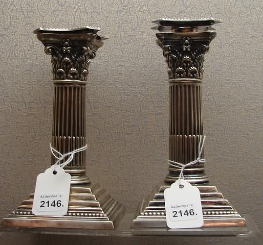 Appraisal: reeded candlesticks with acanthus leaf capitals and stepdown plinth base