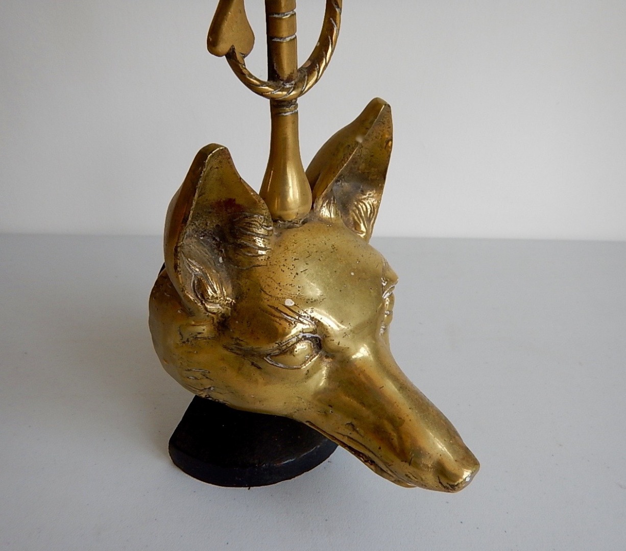 Appraisal: A brass foxes head door porter with riding crop handle