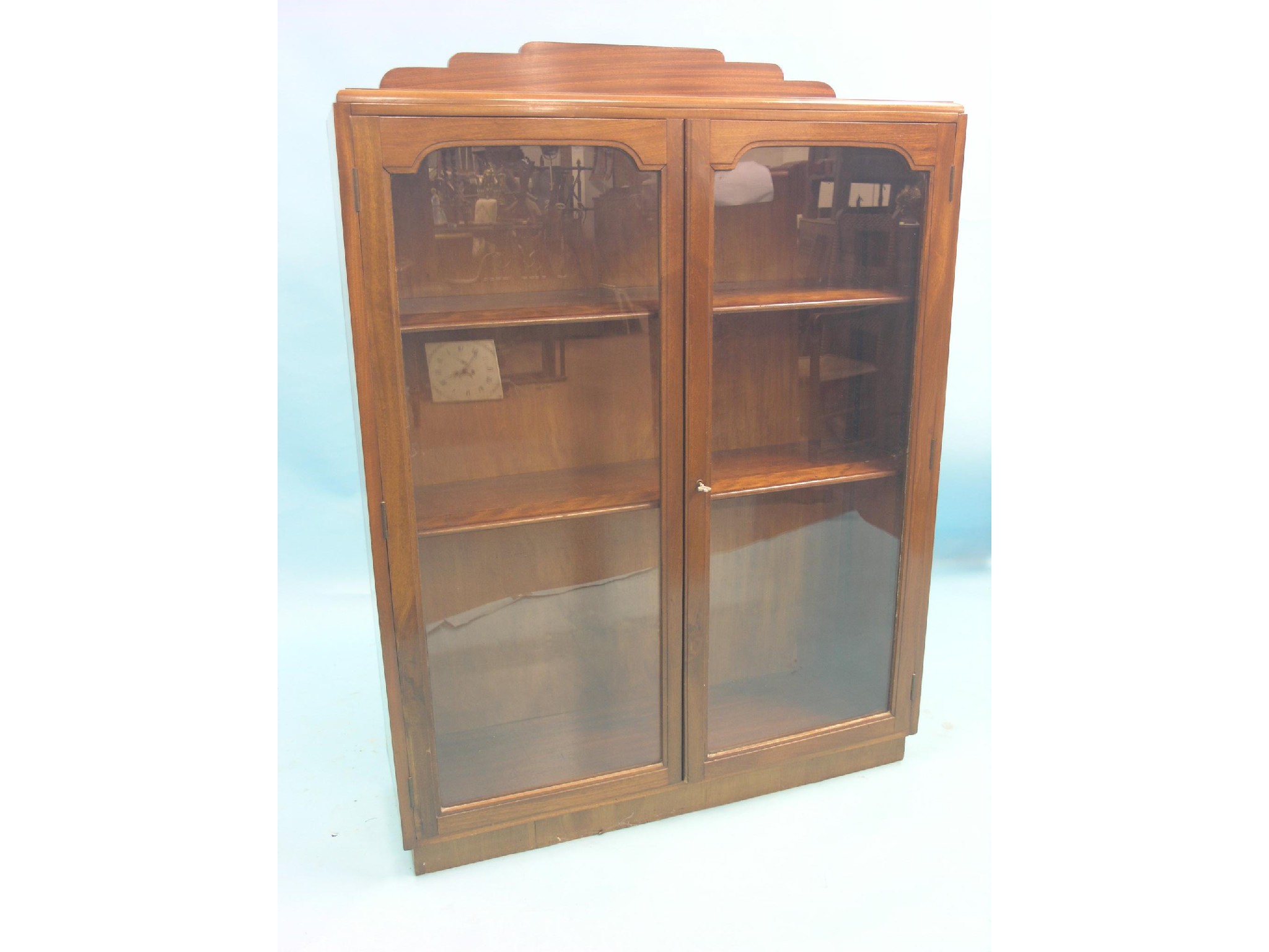 Appraisal: A mahogany display cabinet pair of glazed doors enclosing two