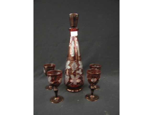 Appraisal: Ruby Cut-to-Clear Decanter and Wine Glasses Bohemian grape vine decor