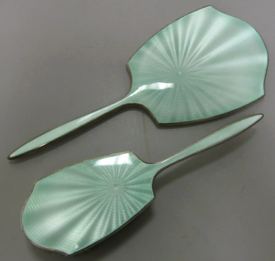 Appraisal: GREEN GUILLOCHE ENAMEL AND SILVER Two-piece dresser set handled mirror