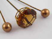 Appraisal: A hat pin set with citrine in yellow metal tests