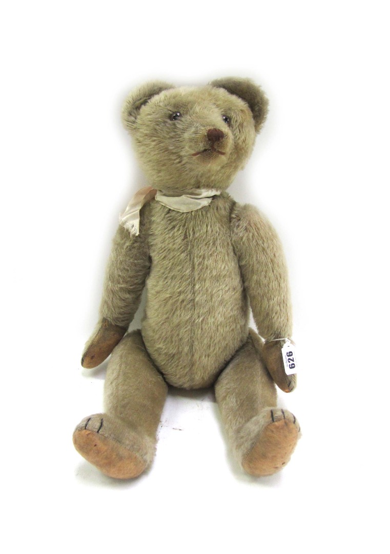 Appraisal: A Steiff musical teddy bear th century with golden fur