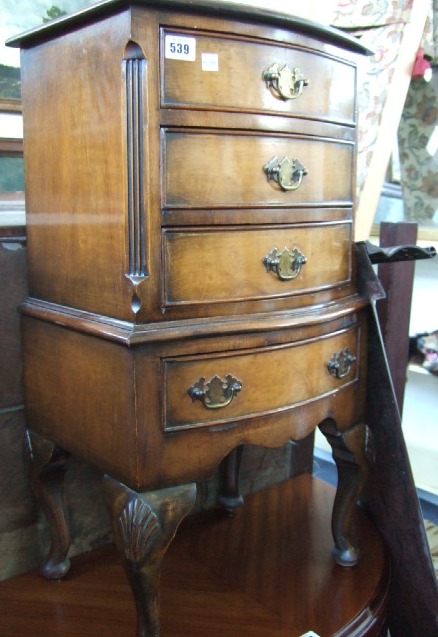 Appraisal: A walnut bowfront four drawer bedside chest and a pair