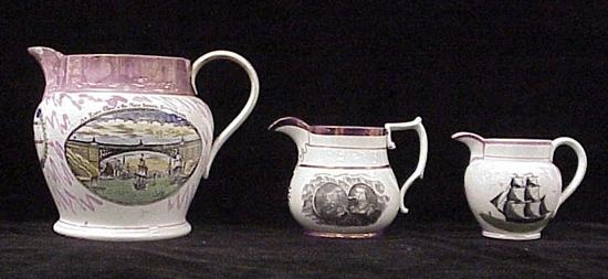 Appraisal: Three pitchers with pink luster decoration English th C the