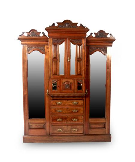 Appraisal: A late Victorian mahogany carved breakfront wardrobe the elaborate cornice