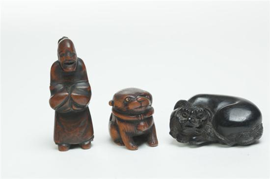 Appraisal: THREE NETSUKES Japan late th-early th century boxwood and ebony