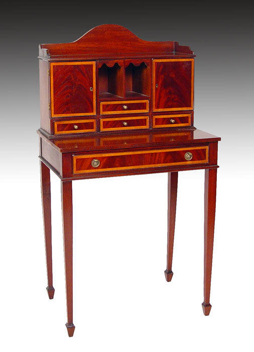 Appraisal: DIMINUTIVE LADIES MAHOGANY WRITING DESK Banded mahogany drawers tapered legs