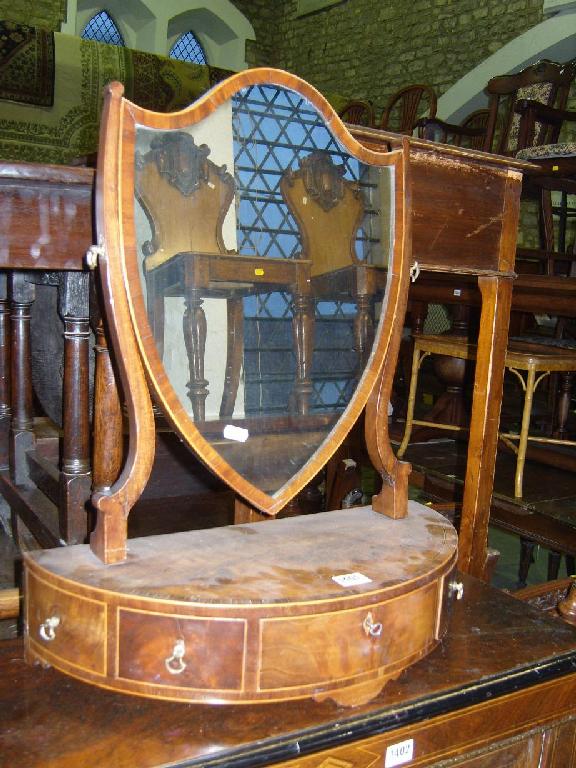 Appraisal: A Georgian mahogany toilet mirror of shield shaped form raised