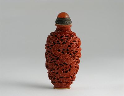 Appraisal: A Chinese porcelain coral ground snuff bottle imitating lacquer moulded