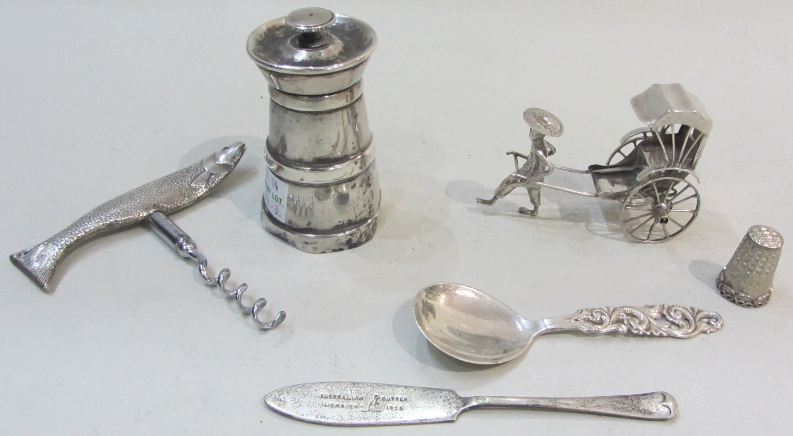 Appraisal: A silver handled corkscrew formed as a fish with red