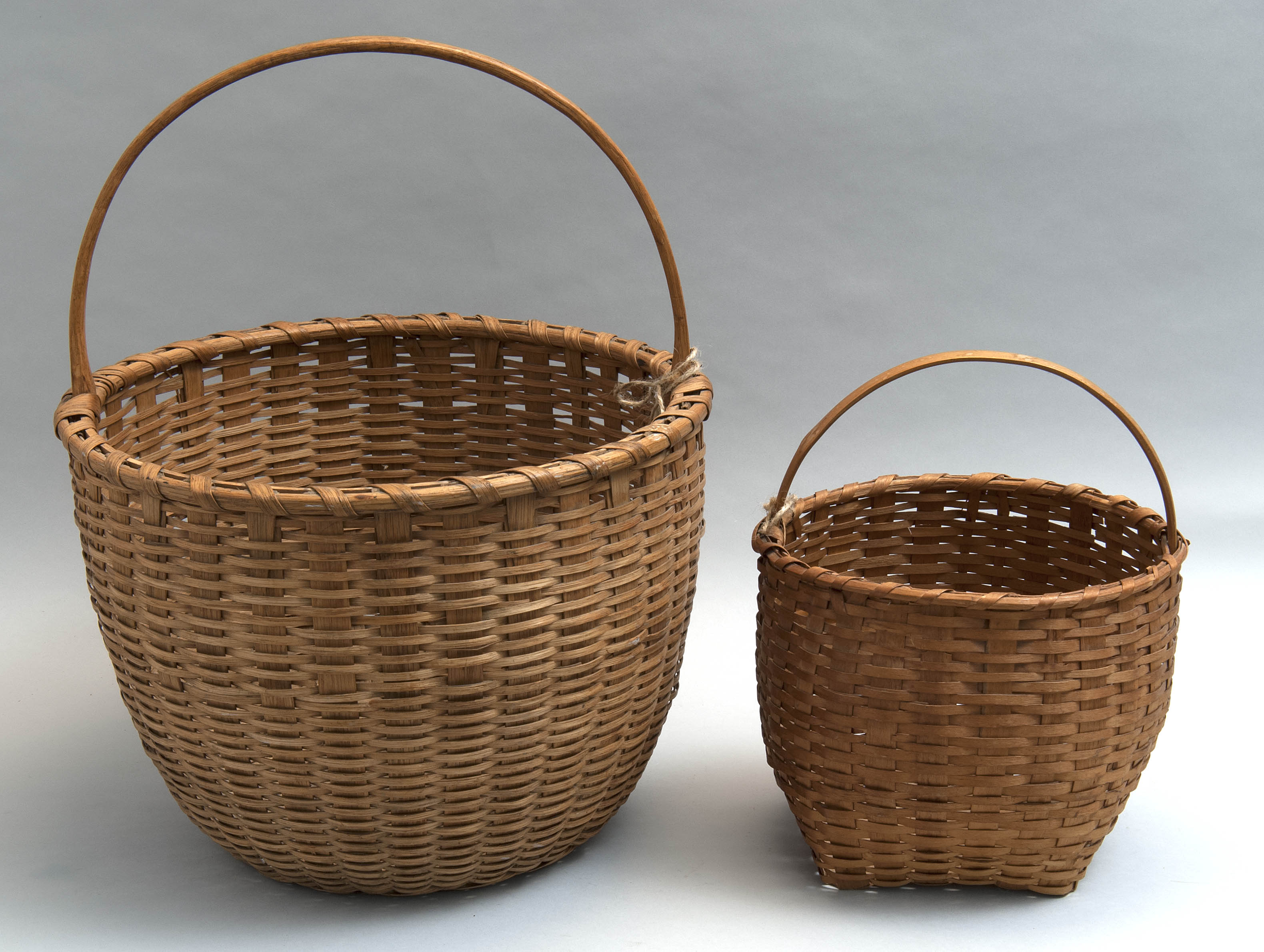 Appraisal: TWO SPLINTWORK HANDLED BASKETS New Hampshire Late th CenturyDiameters and